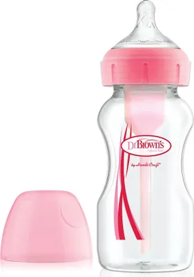 A pink Dr. Brown's baby bottle with a pink cap next to it, set against a white background.
