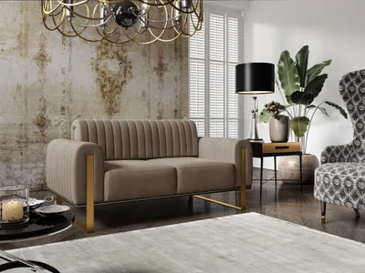A living room scene featuring a sofa, armchair, side table, lamp, and plants.