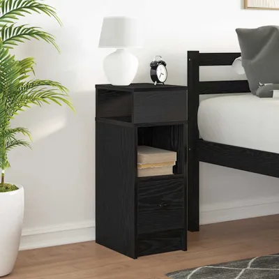 A black nightstand with a drawer and shelves next to a bed.