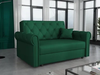 A green sofa with a tufted back and rolled arms is shown in a living room setting.