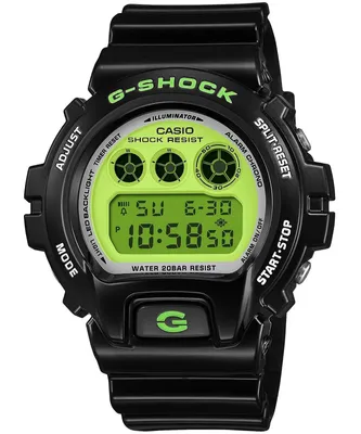 A black G-SHOCK digital watch with a green face and green text, shown from the front against a white background.