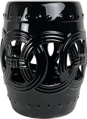 A black ceramic garden stool with a decorative cutout pattern.