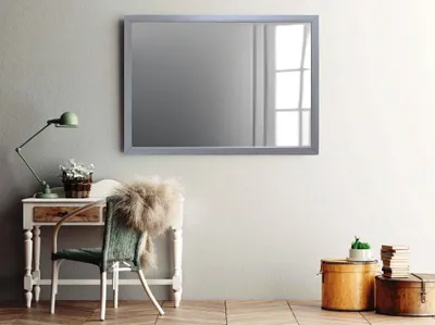 A room with a desk, chair, and mirror.