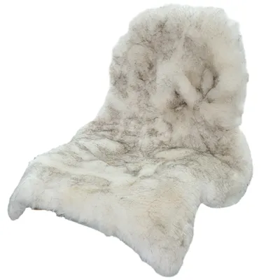 A single sheepskin rug is shown against a white background.
