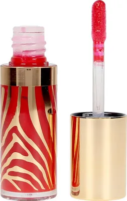 A close-up studio shot of an open lip gloss bottle and its applicator.