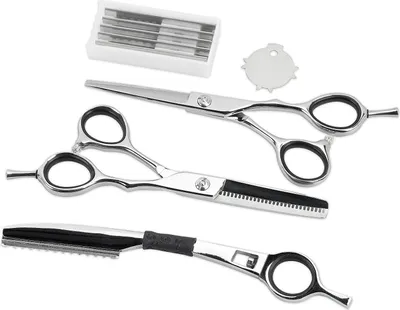 A set of hairdressing tools including scissors and a razor on a white background.
