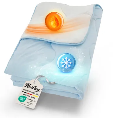 A folded blue and white blanket with glowing orange and blue spheres indicating temperature regulation.