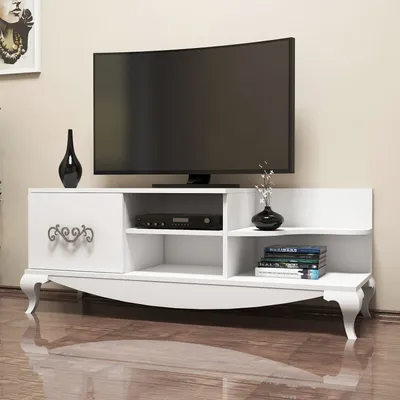 A white TV stand with a television on top, and decorative items.