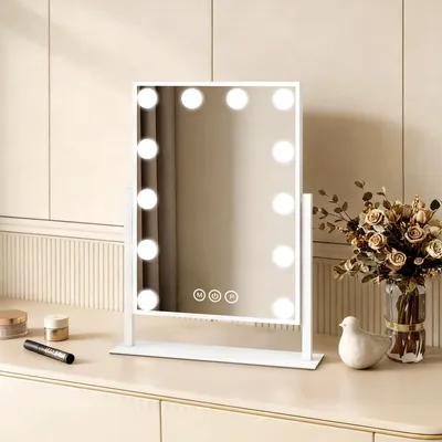 A white makeup mirror with LED lights is displayed on a vanity table.