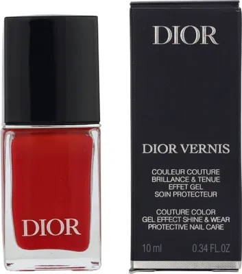 A bottle of red nail polish and its packaging.