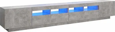 A long, low TV stand with a concrete-like finish and illuminated blue compartments.