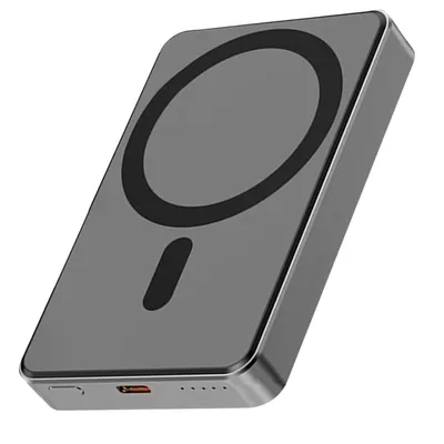 A gray magnetic power bank with a black circular charging area and a black oval indicator light is shown against a white background.