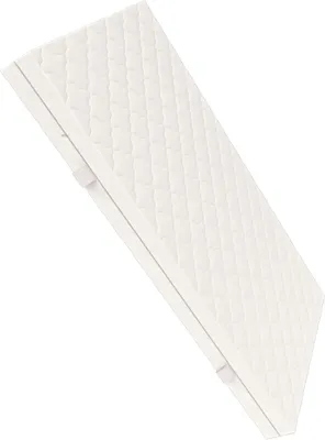 A white quilted mattress is shown at an angle against a white background.