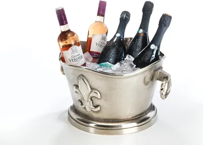 A silver-colored ice bucket filled with ice and several bottles of wine and champagne.