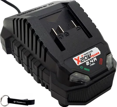 A black battery charger for a power tool is shown on a white background. A black keychain with a white logo is in the bottom left corner.