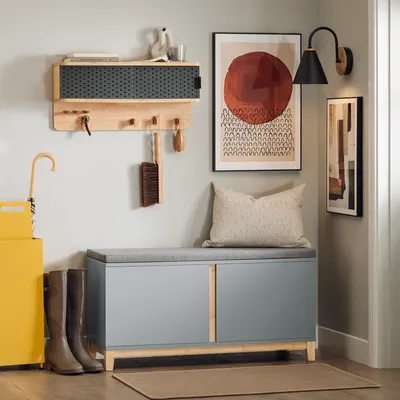 An entryway with a shoe bench, coat rack, and umbrella stand.
