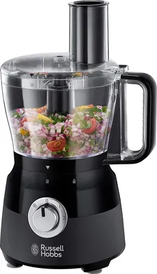 A black Russell Hobbs food processor with chopped vegetables inside the transparent bowl.