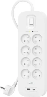 A white Belkin surge protector with multiple outlets and USB ports.