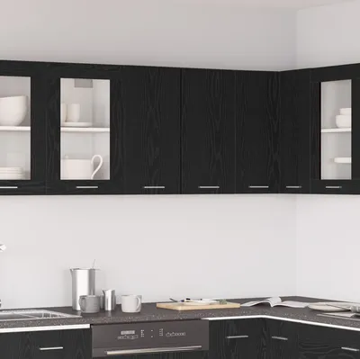 A modern kitchen with black wooden cabinets and white walls.