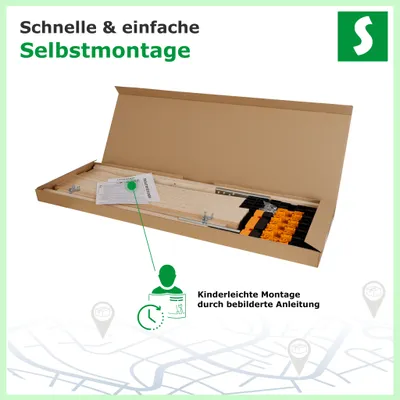 The image shows a cardboard box containing parts of a slatted bed base, along with assembly instructions and some small components.