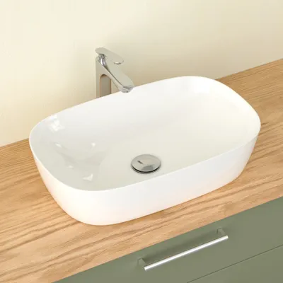 A white countertop basin with a chrome faucet is shown on a wooden countertop.