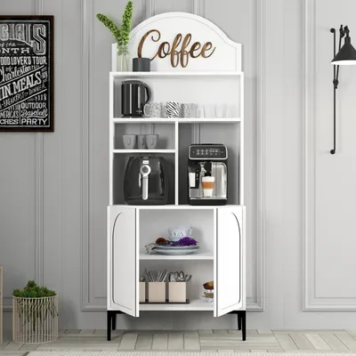 A white coffee bar cabinet with various coffee-related items on display, set against a light gray paneled wall.
