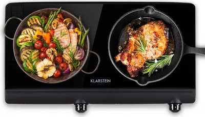 A black Klarstein induction cooktop with two cooking zones, each displaying food being cooked.