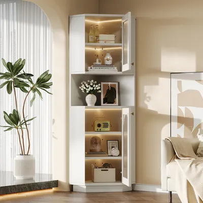 A white corner cabinet with glass doors and interior lighting, displaying various decorative items and bottles.
