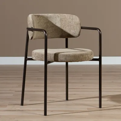 A single chair is shown in a room with a brown wall and wooden floor.