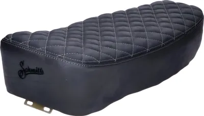 A black motorcycle seat with diamond stitching and a logo.