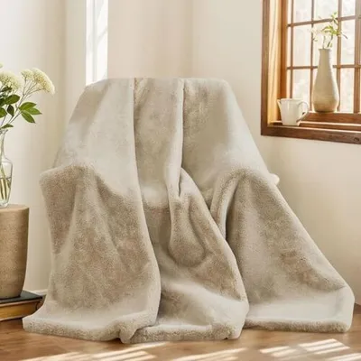 A plush blanket draped over a chair next to a window.