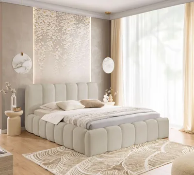 A bedroom scene featuring a large, upholstered bed.