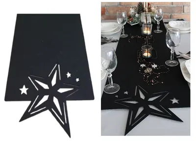 A black table runner with a star cut-out design is laid on a dining table, set for a festive occasion with wine glasses, plates, and candles.
