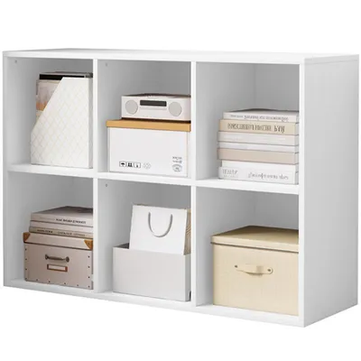 A white cube shelf unit filled with various items.