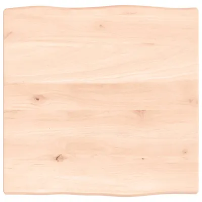 A top-down view of a light-colored wooden tabletop with a live edge.