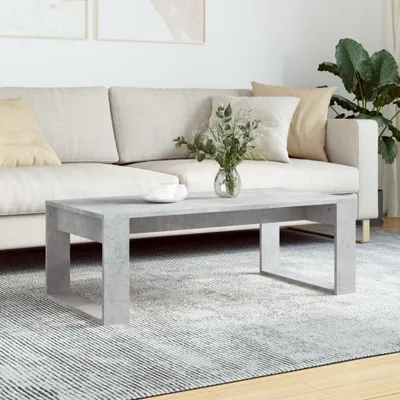 A modern living room scene with a couch, coffee table, and plant.