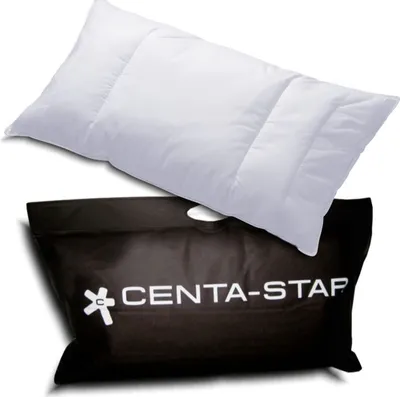 A white pillow is placed on top of a black carrying bag with the brand name printed on it.