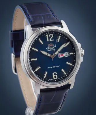 A close-up studio shot of a men's wristwatch with a blue dial and a dark blue leather strap.