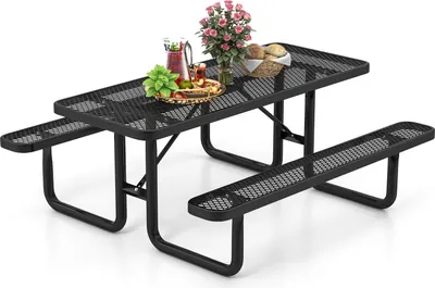 A black metal picnic table with two attached benches, set up on a white background. There are some food items and flowers on the table.