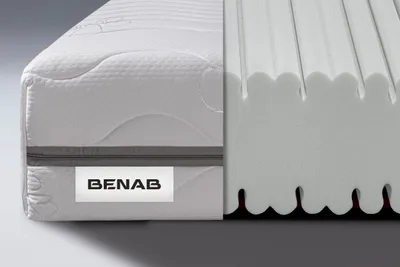 A cutaway view of a mattress showing its internal foam structure, with a label indicating the brand.