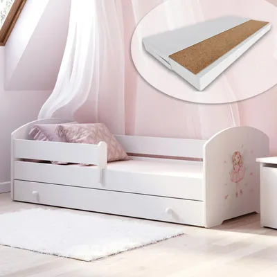 A child's bed with a mattress and drawers, set in a bedroom with pink walls and sheer curtains.