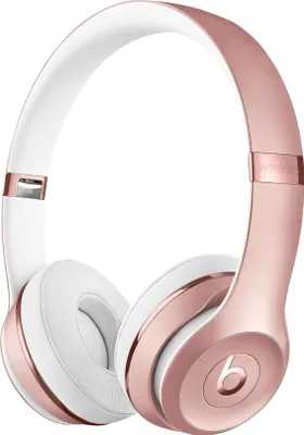 A pair of rose gold and white Beats Solo 3 wireless on-ear headphones.
