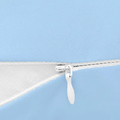 A close-up view of a zipper on a blue fabric product.
