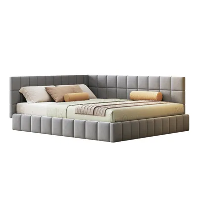 A grey corner bed with pillows and a throw blanket.