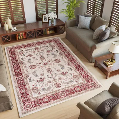 A living room scene with a rug, sofa, coffee table, and chairs.