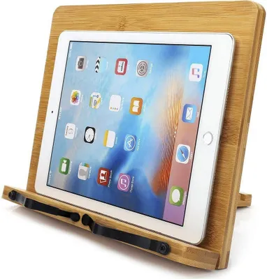 A tablet is placed on a wooden stand.