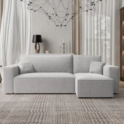 A modern living room scene featuring a light gray sectional sofa.