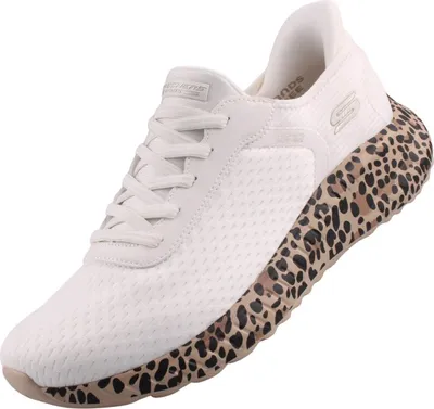 A single white sneaker with a leopard print sole is shown against a white background.