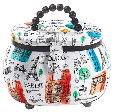 A sewing basket with a Paris-themed print.