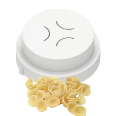 A pasta cutter and a pile of orecchiette pasta.